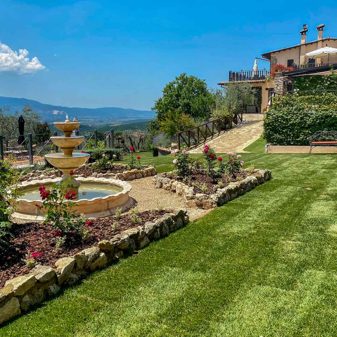 A stunning garden landscape with mountains in the background on a beautiful sunny day